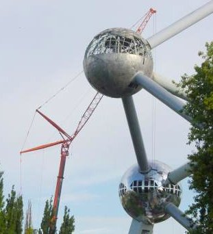 Photo d'une boule de l'Atomium à moitié démontée: on voit le ciel à travers la structure de la partie supérieure